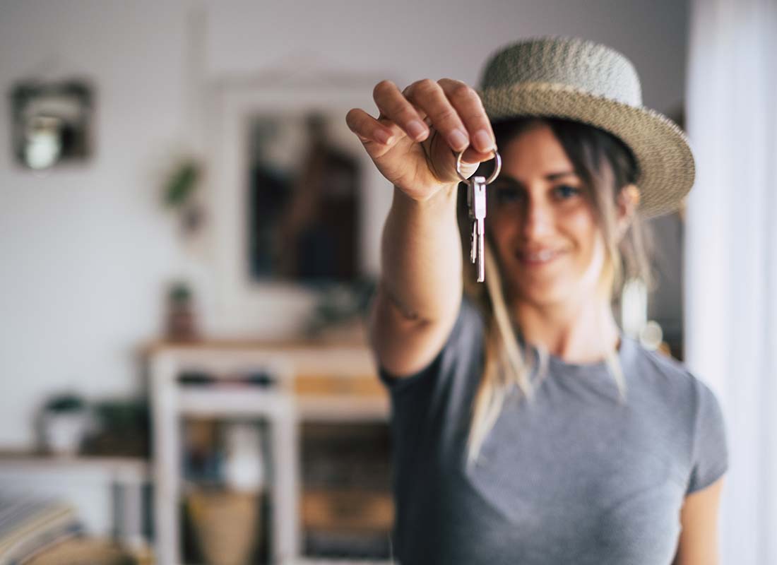 Renters Express Program - Close up Blurred Image of a Happy Female Tenant Proudly Displaying House Keys in Focus as She Moves Into Her First Apartment