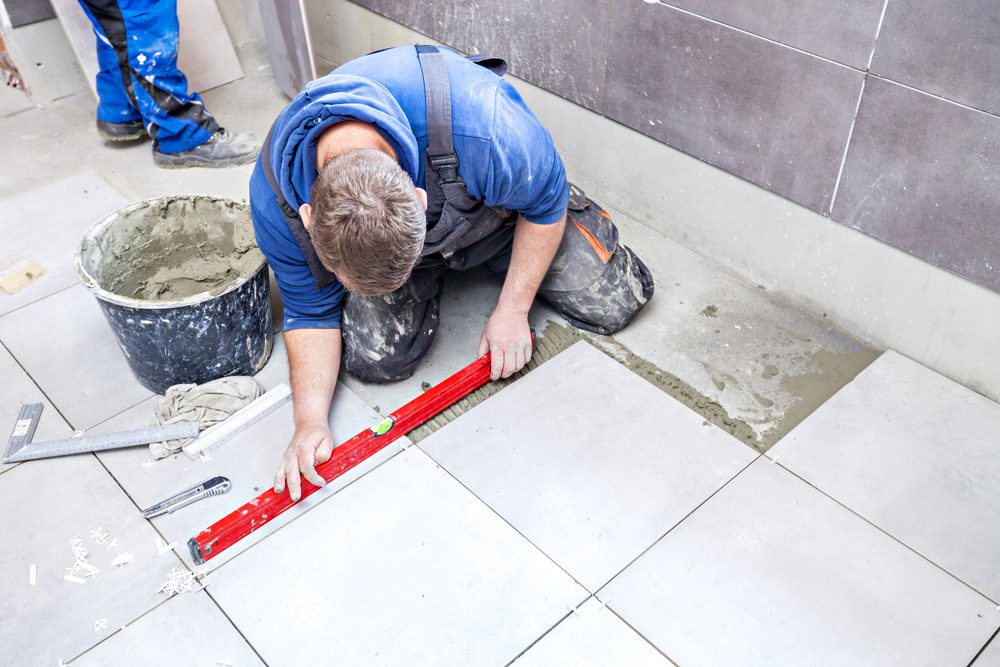 Tiling Floor & Wall. The tiler builder arranges the bathroom ceramic