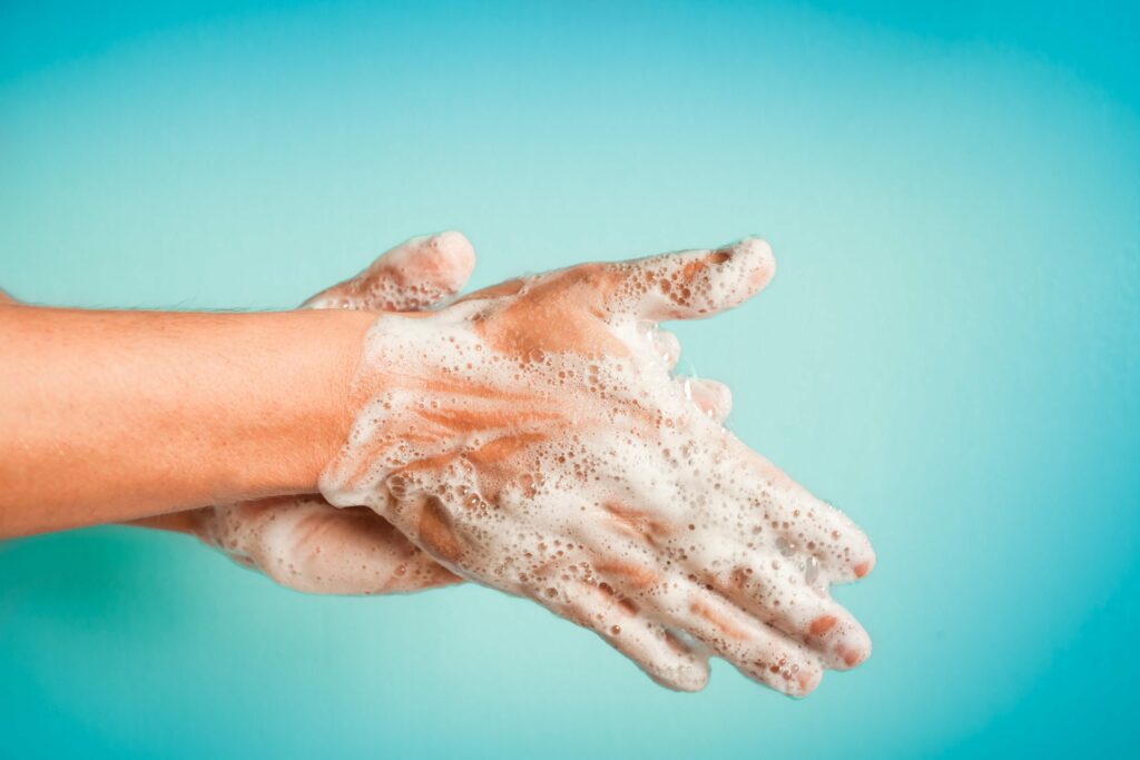 pair of soapy hands washing to prevent COVID-19