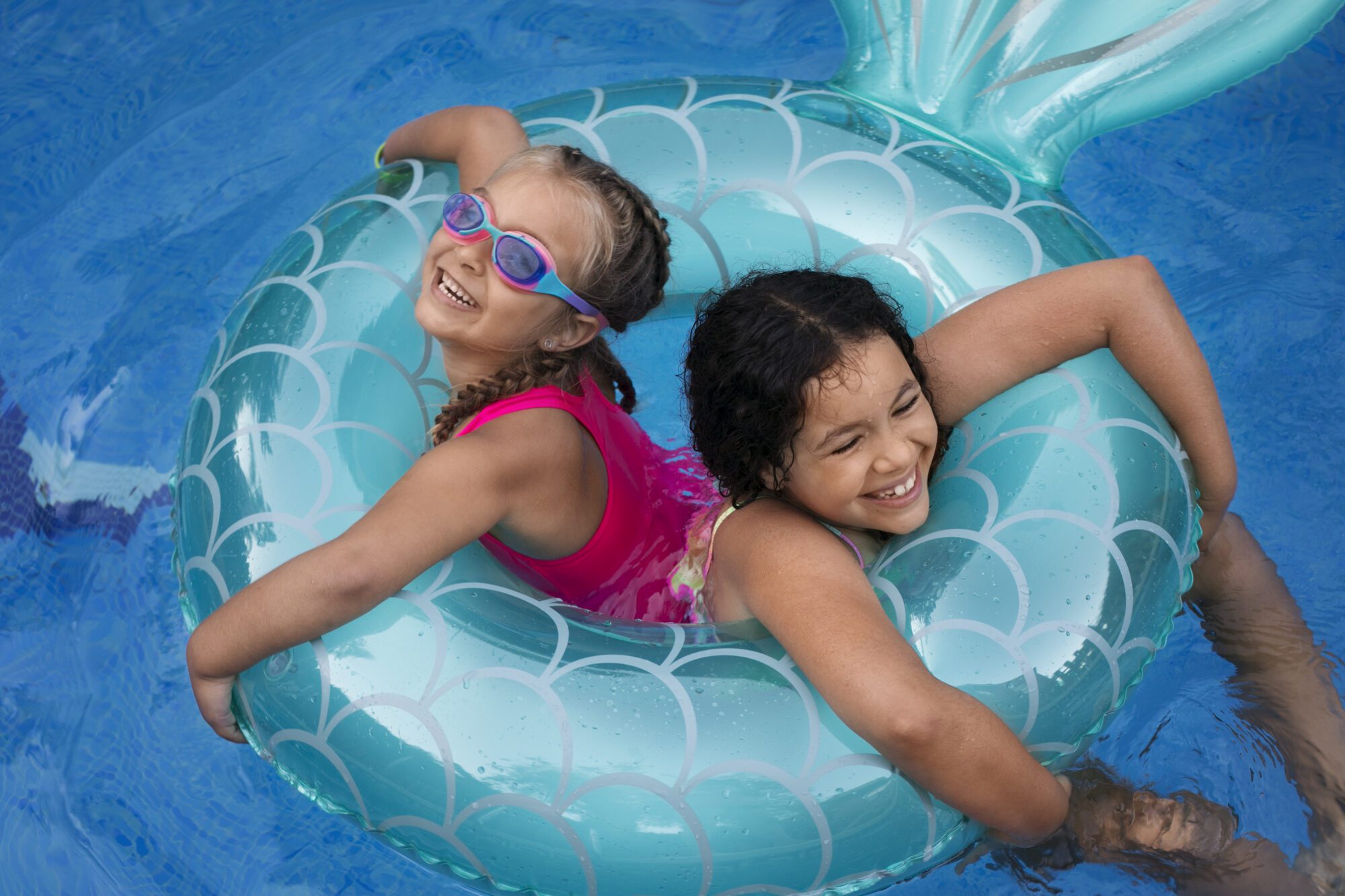 Kids having fun in insured pool at home