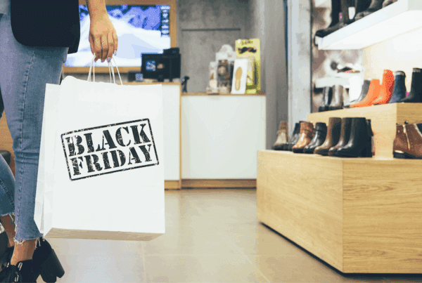 Customer carrying a Black Friday shopping bag in a local shoe store, representing holiday shopping in the Lehigh Valley and Poconos.