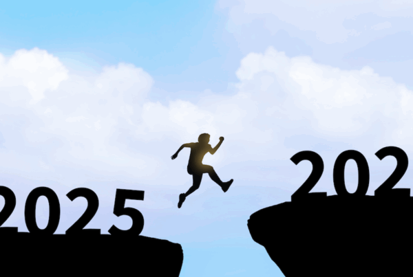 Silhouette of a person leaping across a gap from “2025” to “2026,” symbolizing transition into the new year and moving forward with confidence against a blue sky background.